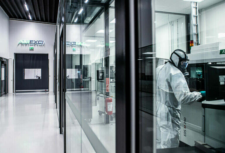 Additive manufacturing employee working with machine at AMEXCI